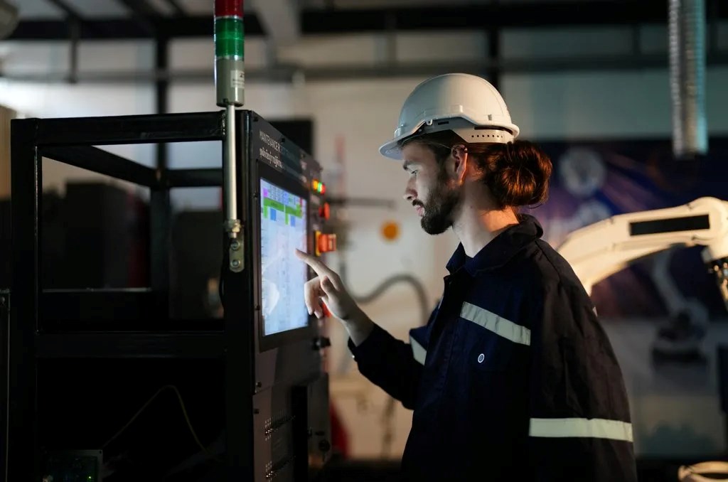 Man using touch screen IIoT technology